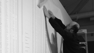 Ian Boyden installing the Names of the Student Earthquake Victims Found by the Citizens’ Investigation (2008-2011) by Ai Weiwei. Photograph by Patricia Bolding.