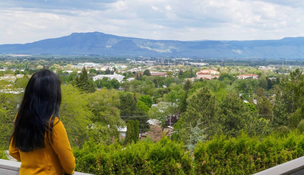Woman looking out over the Grande Ronde Valley from the EOU Campus