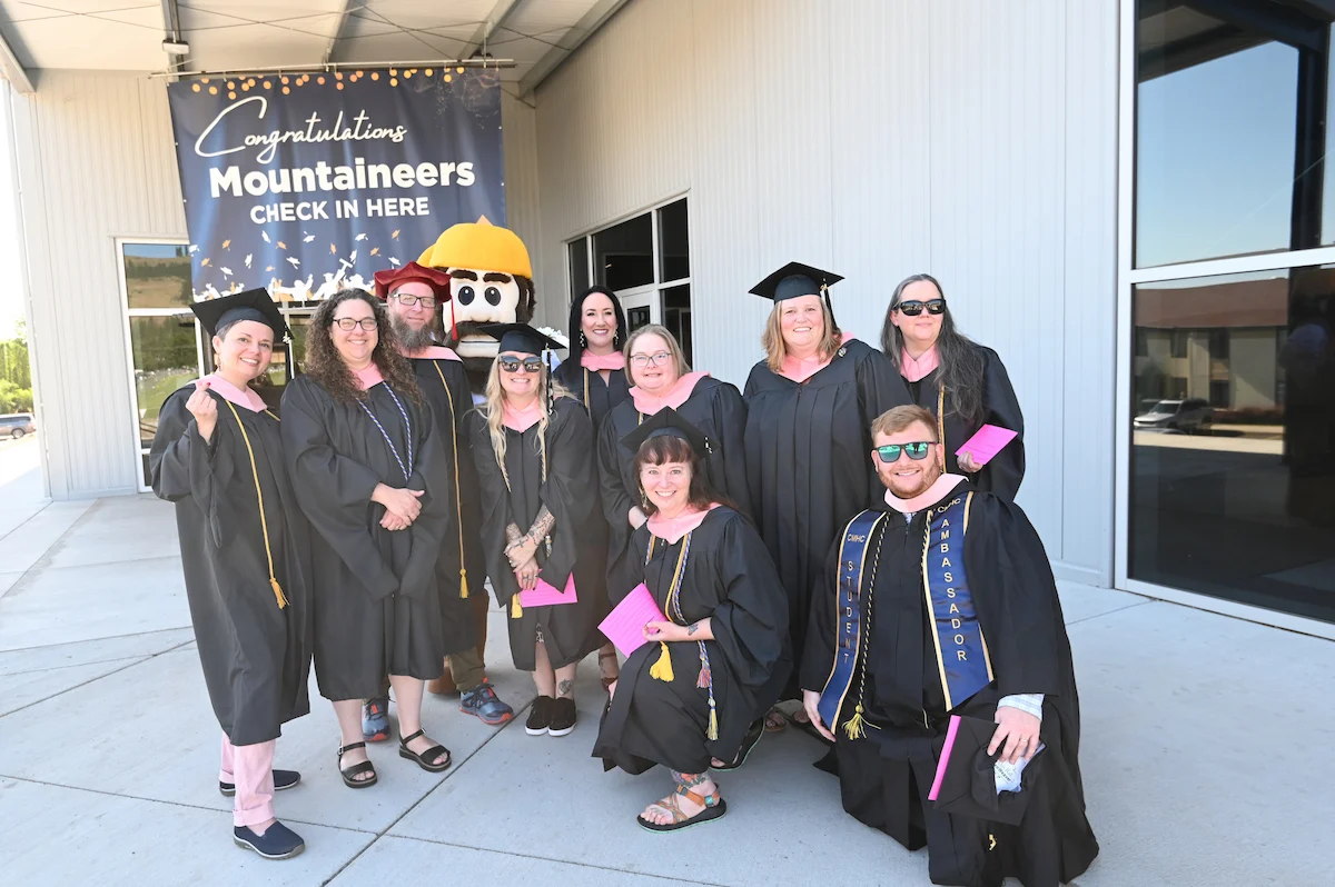 The first cohort of the Master of Clinical Mental Health Counseling program poses outside of the EOU Fieldhouse on commencement day 2026