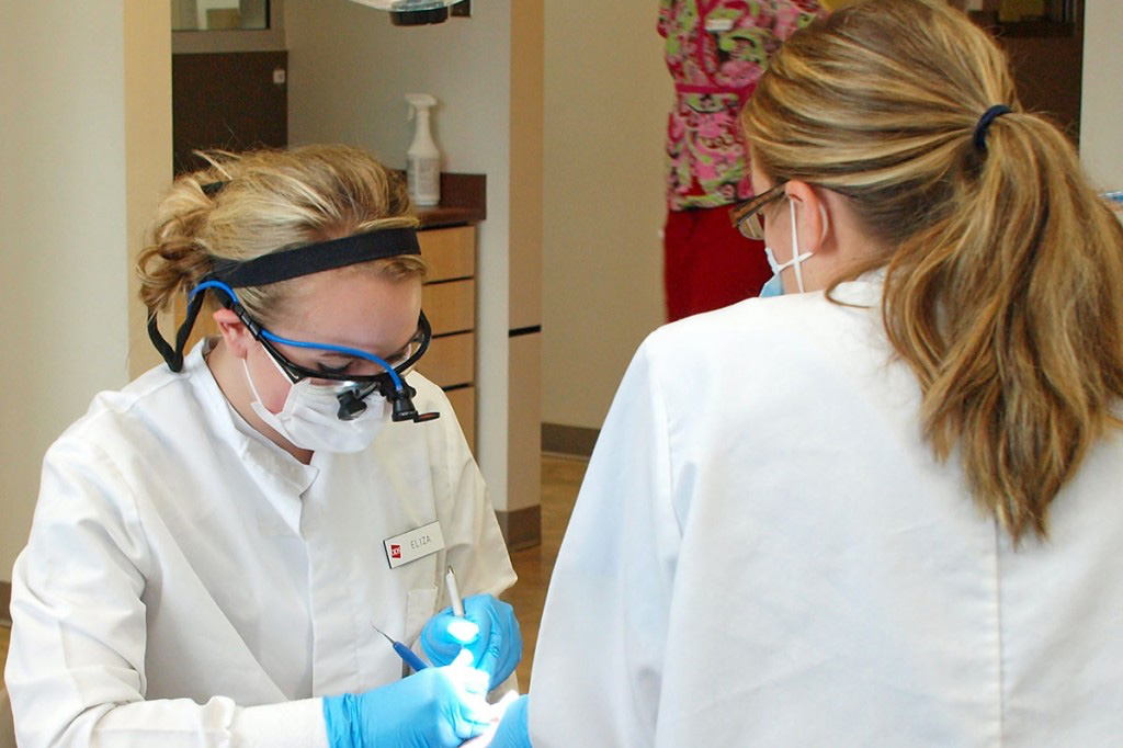 Preprofessional health students practice medicine on dummies in lab