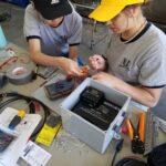 CCSI students wiring a solar charger battery