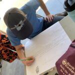 Student preparing a cut list for a solar bench