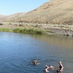 Students swimming in the John Day River at CCSI 2021