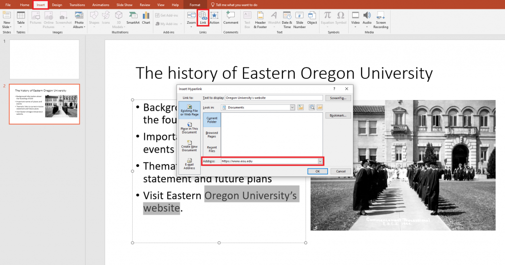 Inserting a hyperlink into a PowerPoint slide using the link button under the insert section of the toolbar.