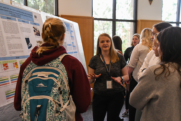 A student presents their work at Spring Symposium