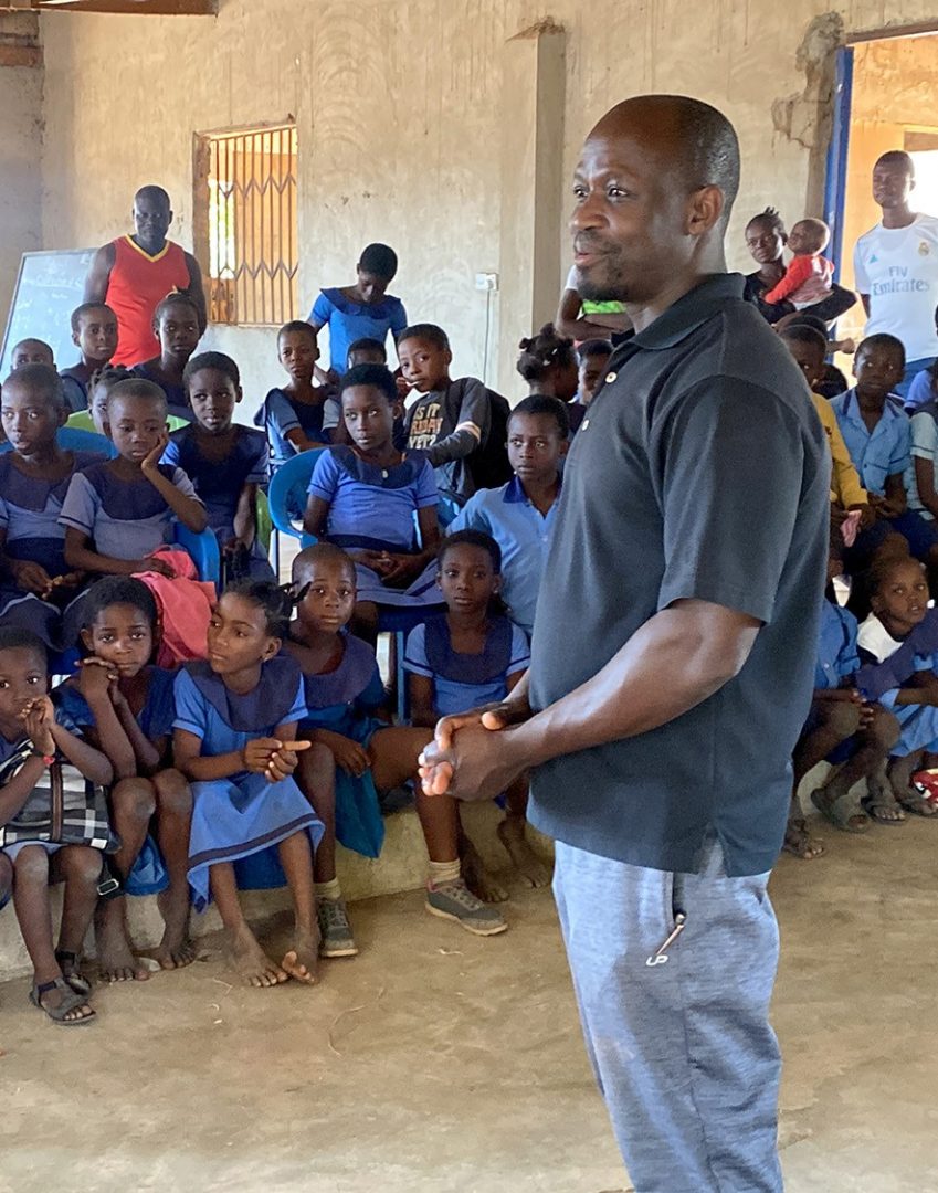 EOU alum Doctor Abio Ayeliya (far right), '08, gives back to his childhood village in Ghana. (Submitted photo.)