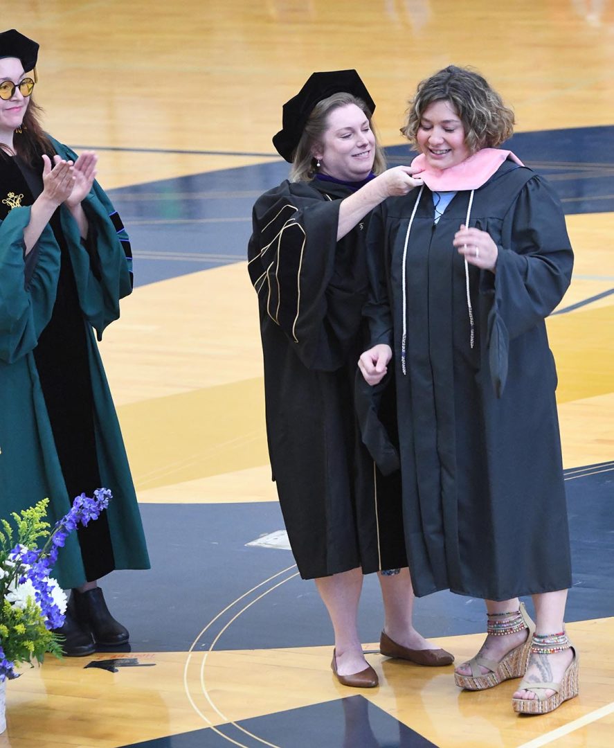Kate Gekeler getting hooded at Commencement