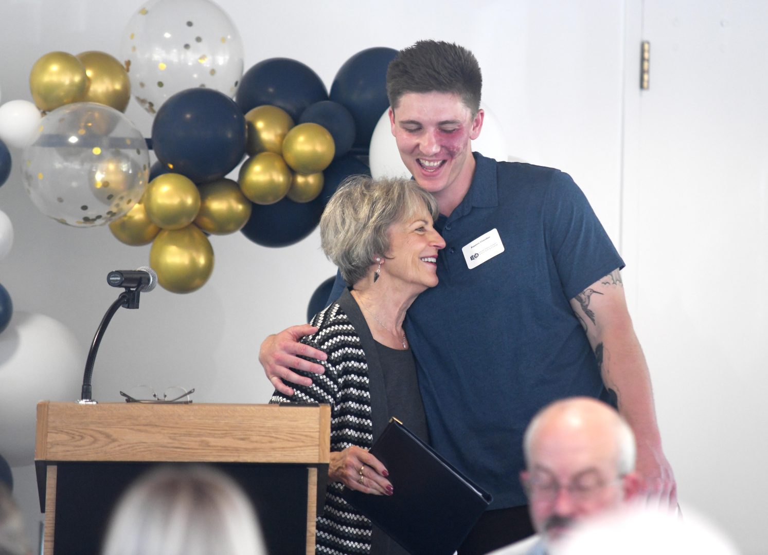 Scholarship awardee hugs donor at the Celebration of Scholarships dinner