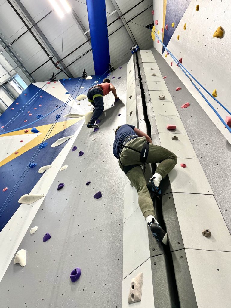 Students climbing on the main climbing wall in the EOU Climbing Center
