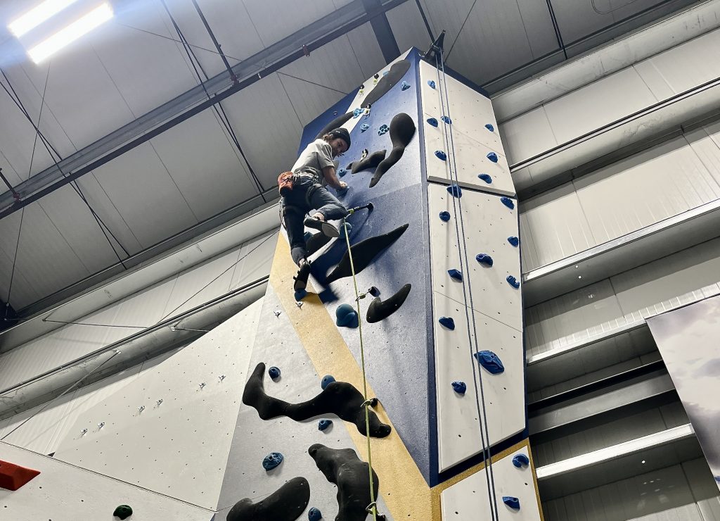 EOU student lead climbing on pillar at OAP Climbing Center. 