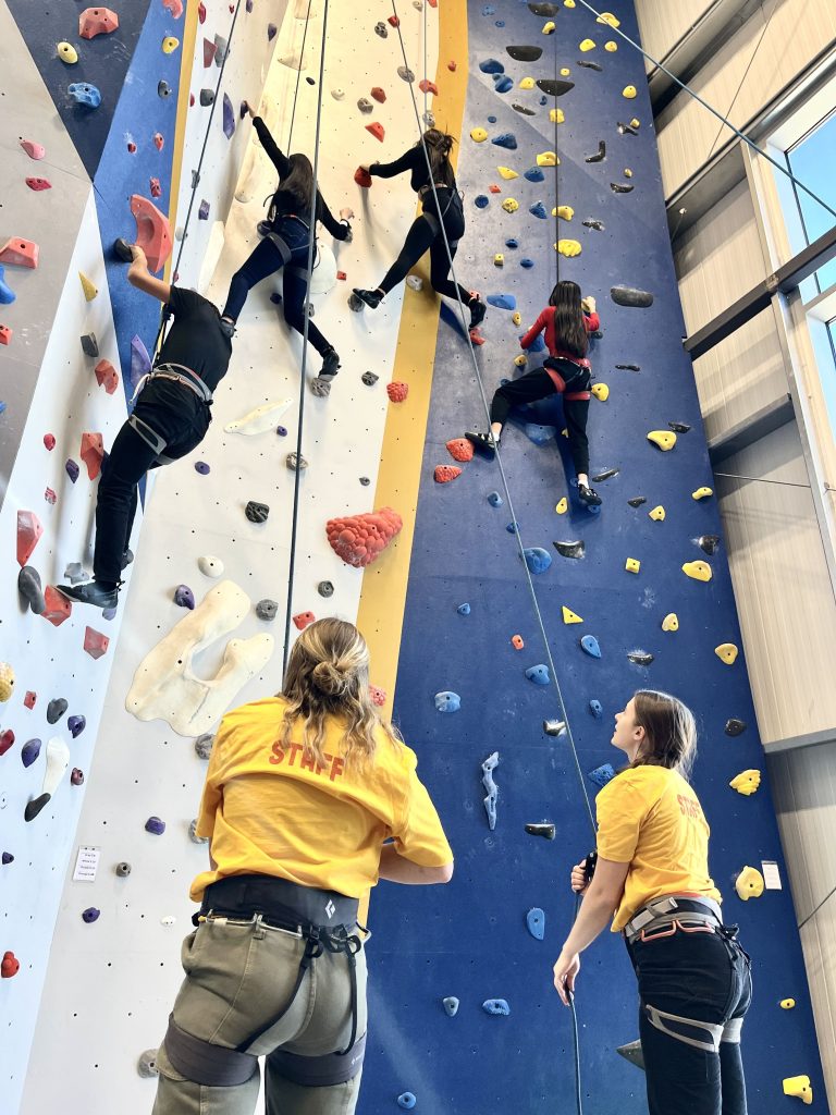 OAP employees belaying EOU students at the climbing center. 