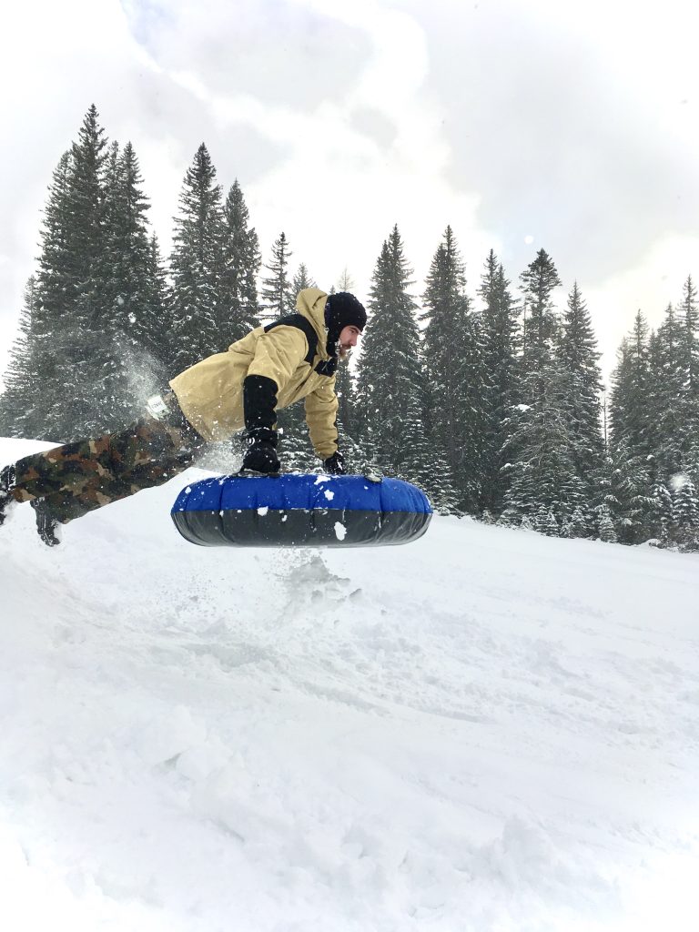 EOU student sledding at Spout Springs
