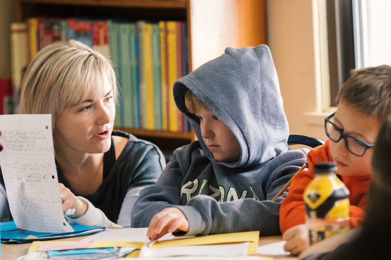 A Teacher helping students