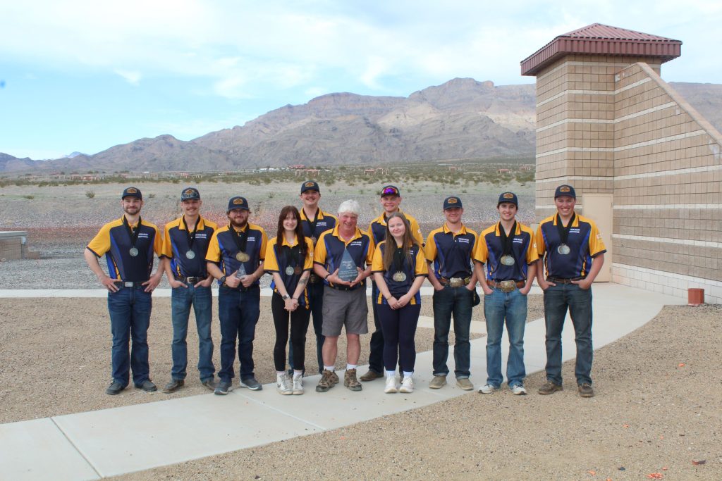 Team photo in Las Vegas with trophies