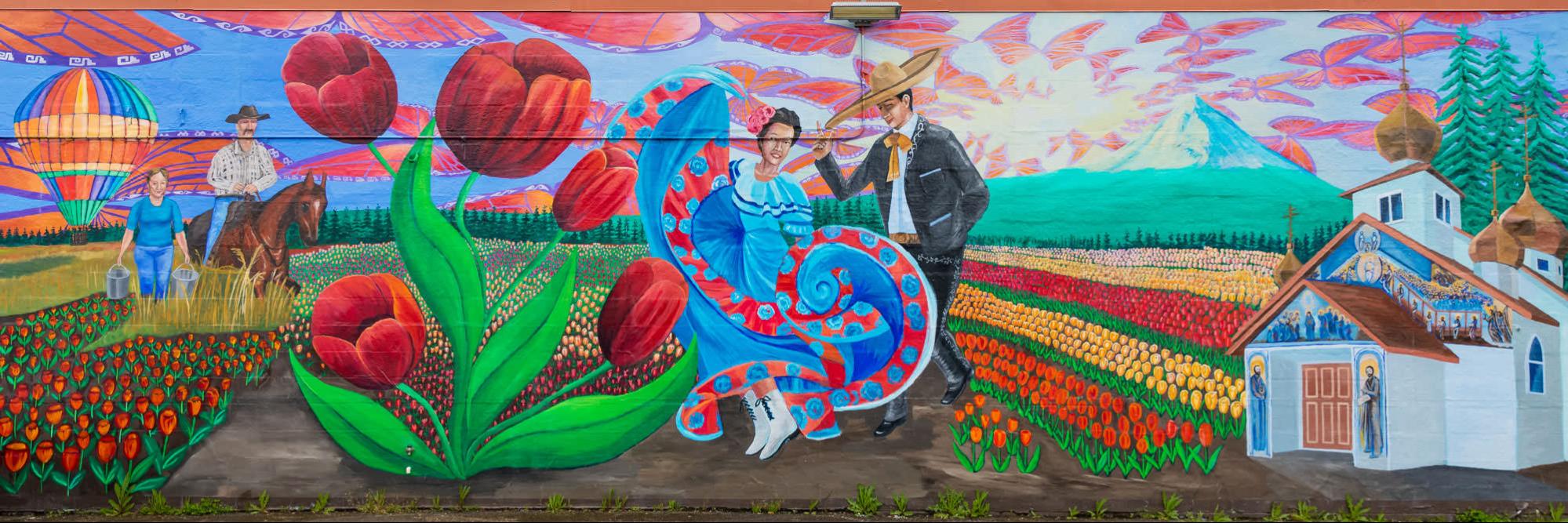 Mural showing a field of flowers with people wearing traditional Spanish clothing