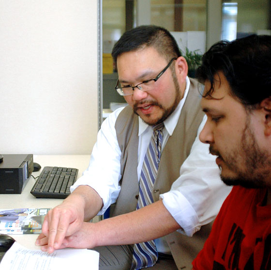 Justin Chin, director of Career Services, shares information on a job lead with EOU student Matt Muritok. 
