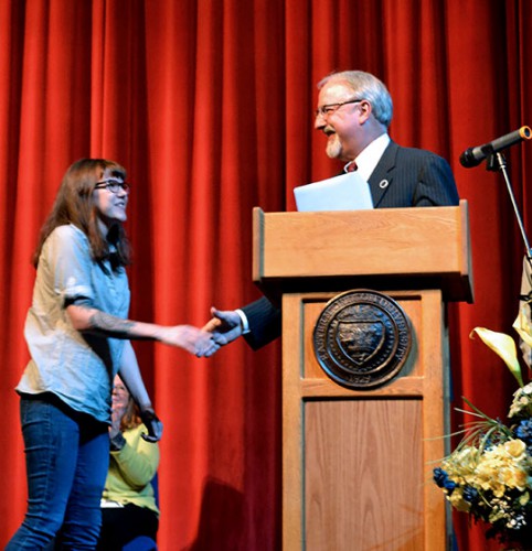 Interim EOU President Jay Kenton congratulates Presidential Art Award recipient Genevieve Gaudreau