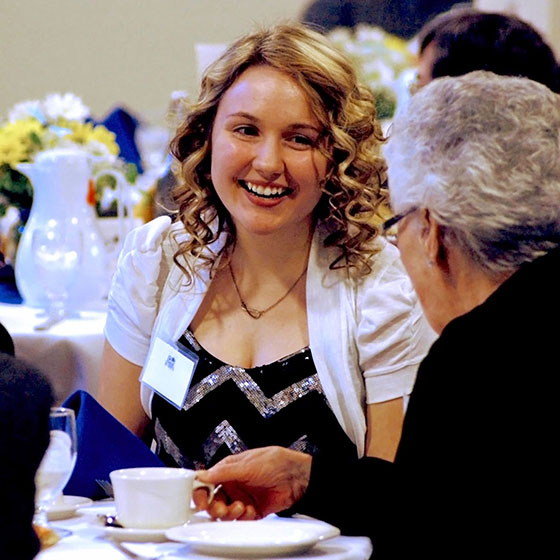 EOU file photo / Scholarship recipient Nyki Anderson visits with a donor at the annual Tea and Trumpets reception celebrating students and benefactors.