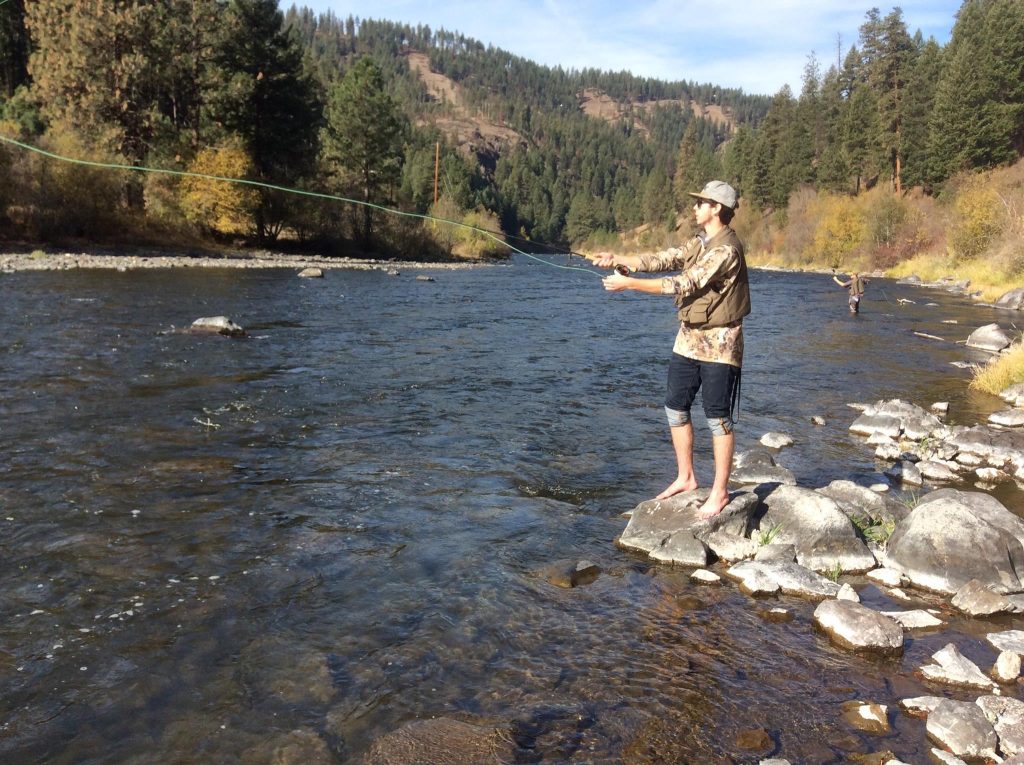 EOU student fishing along Wallowa River.