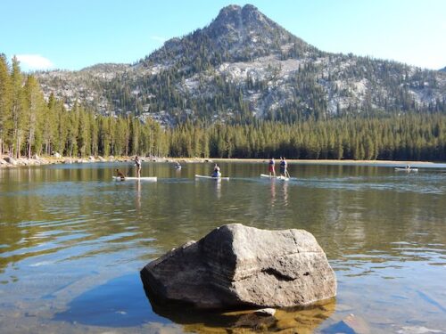 Picture of eou students paddleboarding on an alpine lake