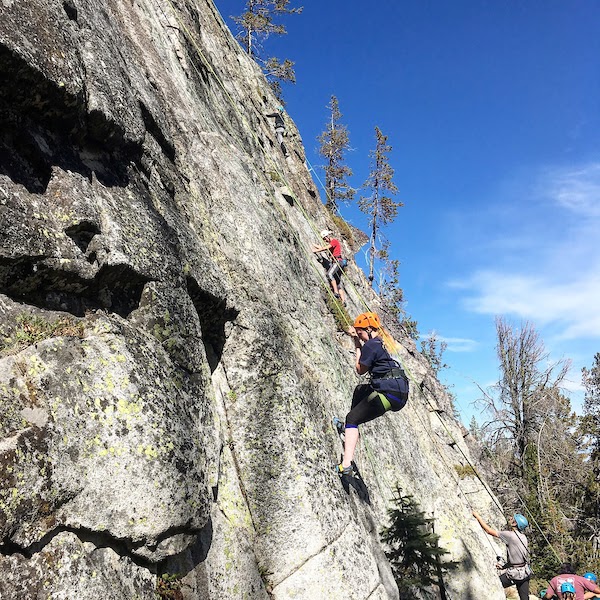 people climbing a rock