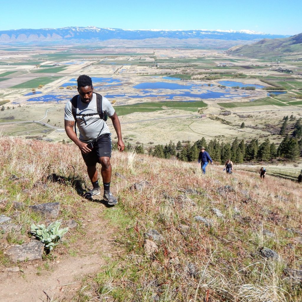 EOU student hiking up Glass Hill above Ladd Marsh.