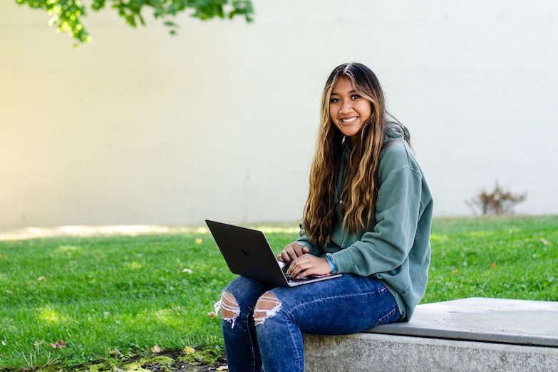 A student studying in the EOU Quad