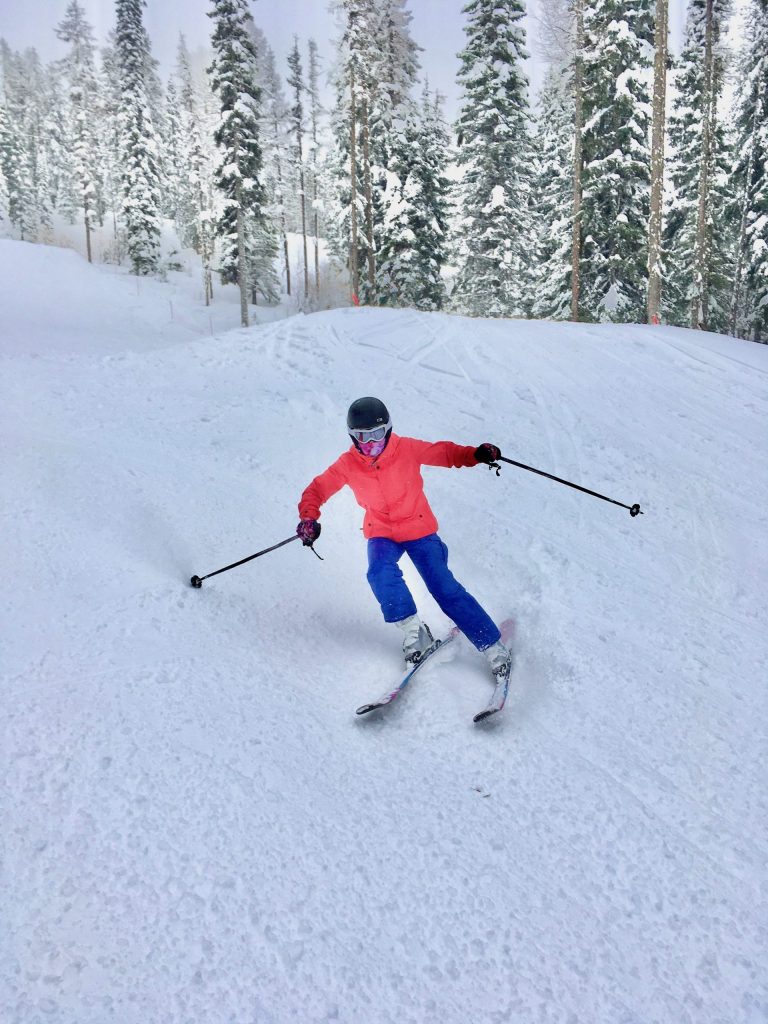 A skier making turns on the slopes and representative of skills learned when taking the OUT 180 Beginning Skiing course. 