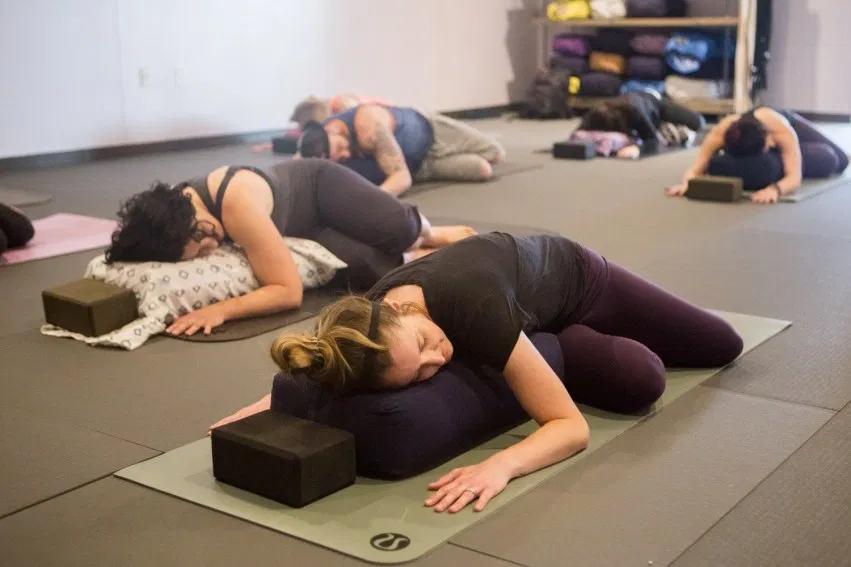 Image of women doing yoga and representative of students taking the OUT 180 yoga courses. 