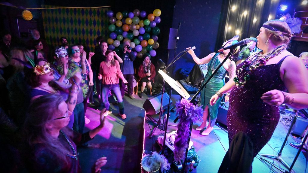 People dancing during the Mardi Gras 2024Performance at HQ in downtown La Grande