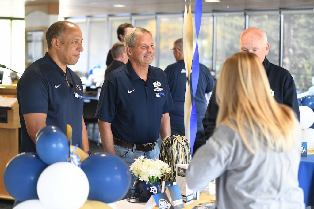 EOU Alumni standing at an event