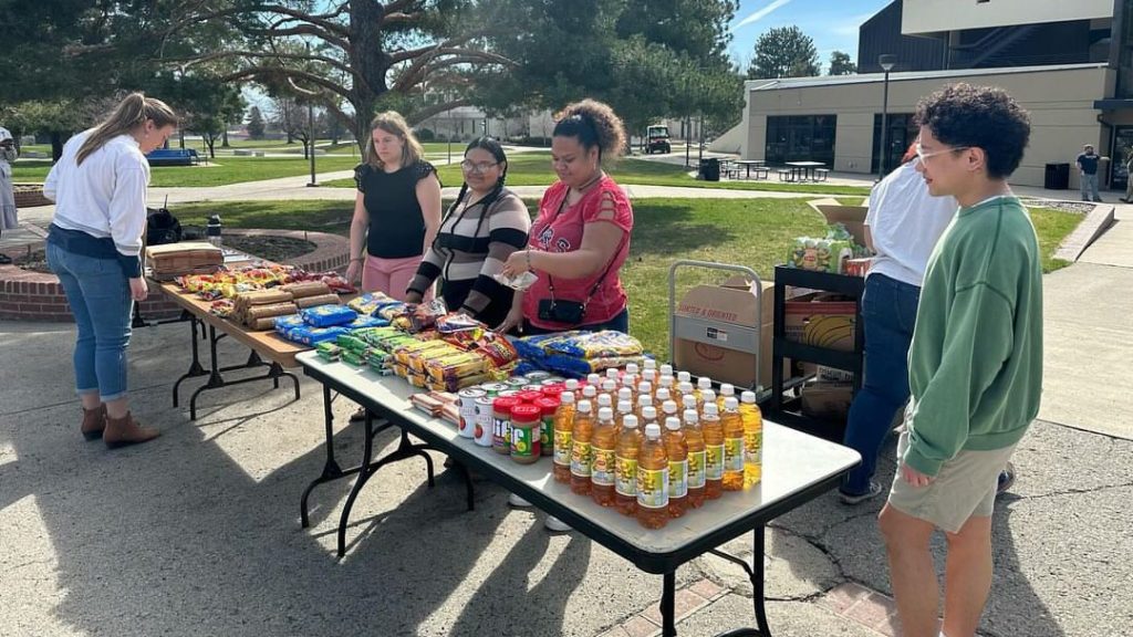 Student leaders taking on the Fall 2024 Finals Week Survival Kits event where they share and pass out snacks to energize students during their finals.
