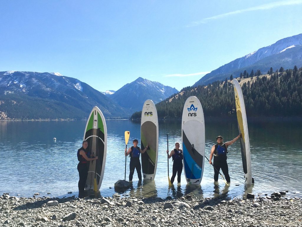 EOU students posing with paddle boards at Wallowa Lake.