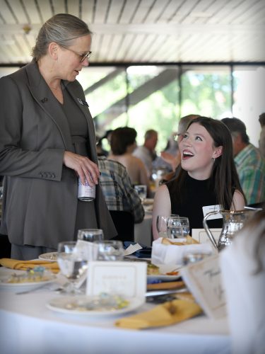 EOU President Dr. Kelly Ryan speaking with a student. 
