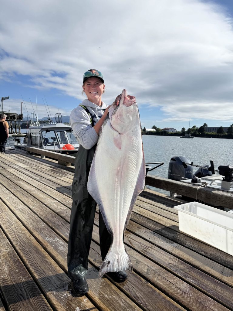 OAP worker Megan with a huge halibut caught in Alaska.