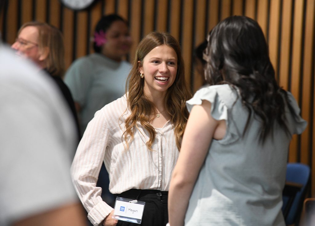 In this photo Megan meets with another student while attending a special event.While at EOU Megan Gustafson had the opportunity to meet and learn from Bill Imada, Chief Connectivity Officer of IW Group and founder of the National Millennial and Gen Z Community (NMGZ). (Michael K. Dakota /EOU Photograph)