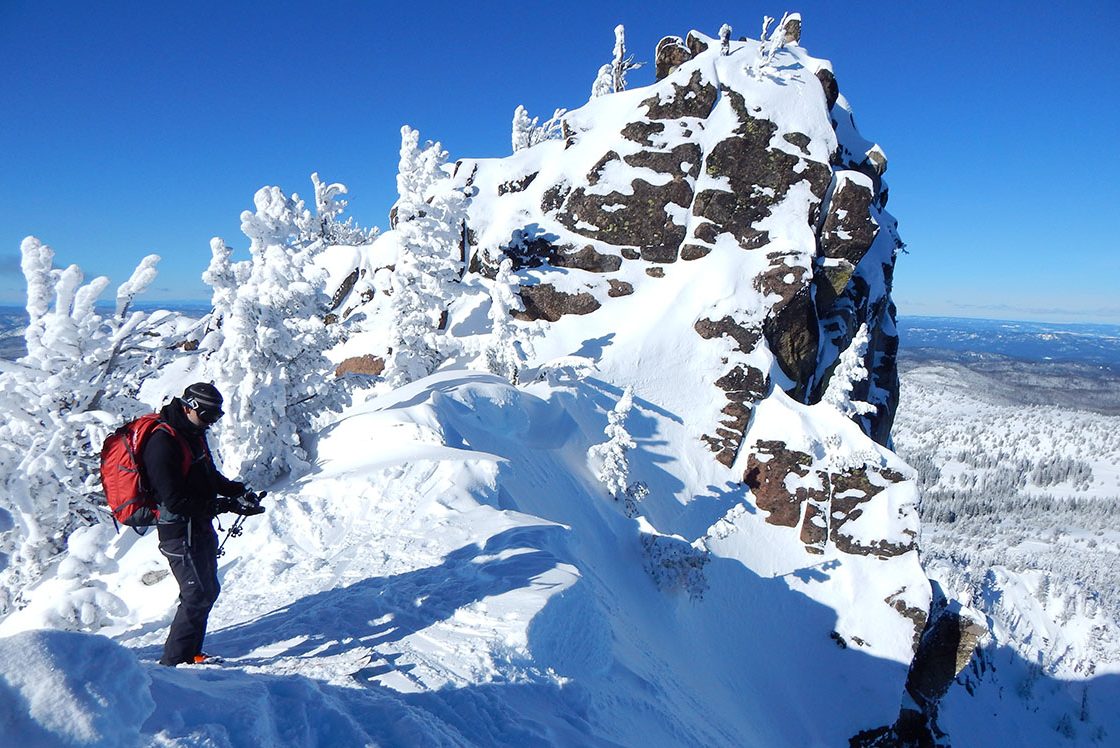 EOU Outdoor Program students on top of a snowy mountain