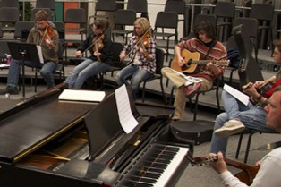 The Fiddle Ensemble in the music room practicing