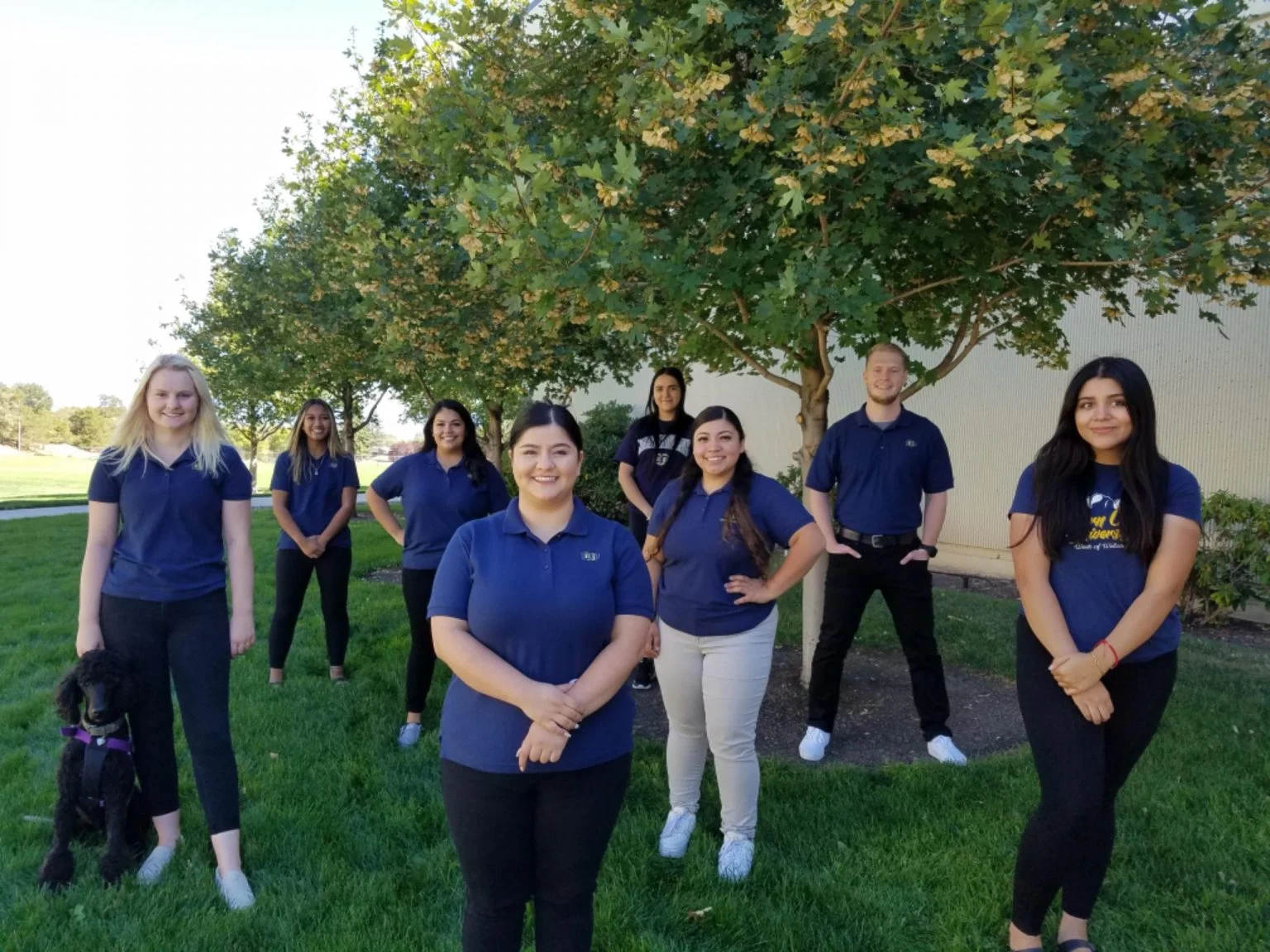 EOU Tour Guides posing and smiling on campus