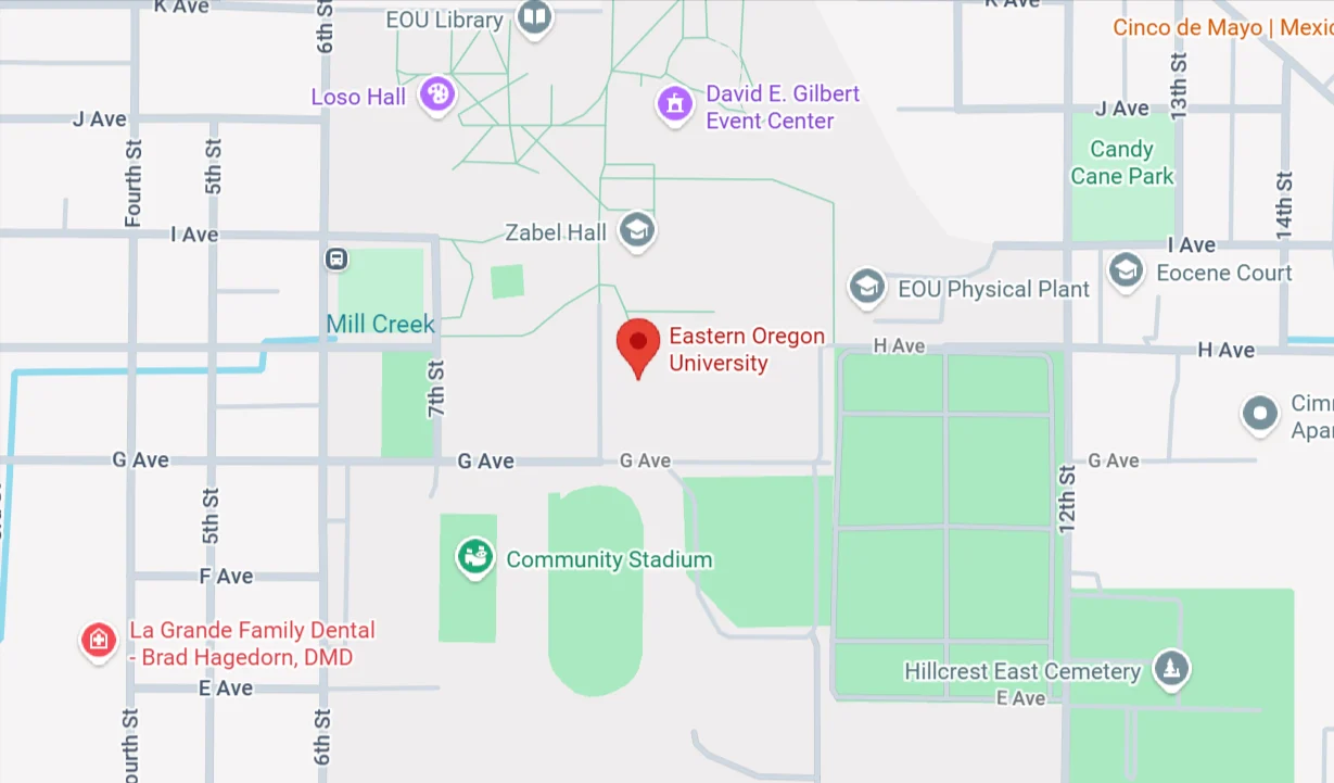 Google Maps view showing the campus of Eastern Oregon University marked with a red pin, surrounded by nearby streets, campus buildings, and Community Stadium.