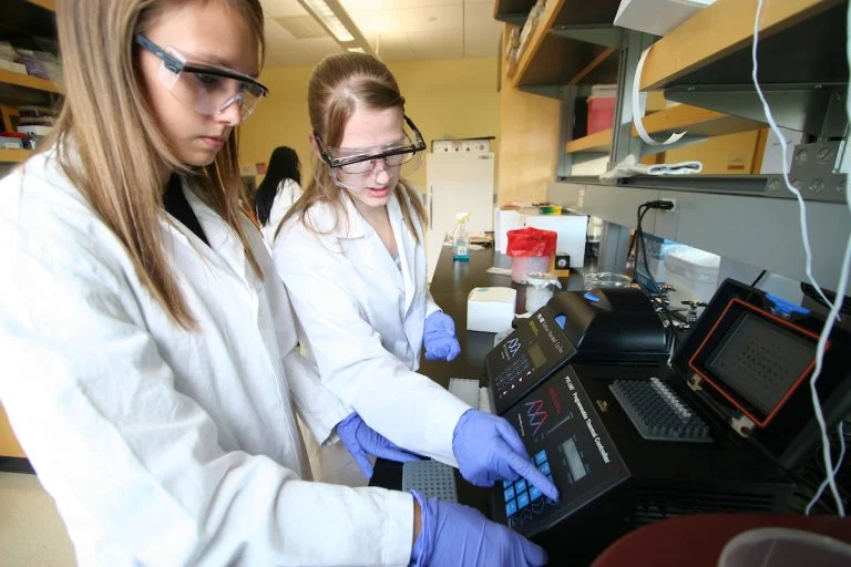 Chemistry students working with devices in the EOU Chem lab